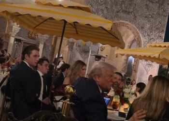 Barron Trump (pictured left) was spotted at his father's side but in the background during Donald Trump's (pictured center) holiday dinner at Mar-a-Lago