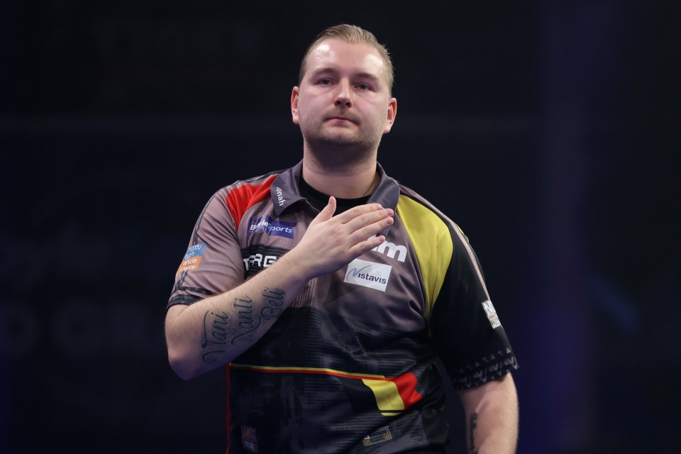 Dimitri Van den Bergh reacting during a darts match.