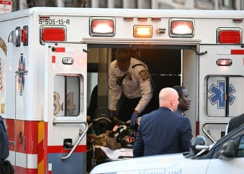 An unidentified man in military fatigues lies on a stretcher inside an ambulance on Nov. 26, 2025, in downtown Washington, D.C.
