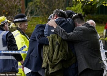 Members of the Jewish community comfort each other outside the Heaton Park Hebrew Congregation synagogue. In the wake of the October terror attack, the government will provide an extra £10million to guarantee the safety of the Jewish community