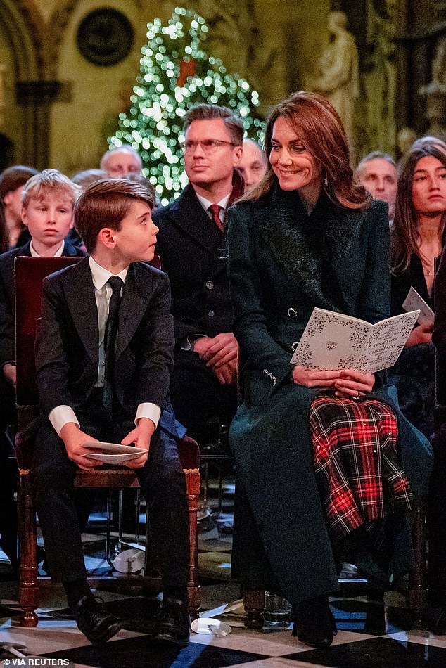 Kate Middleton beaming a loving smile at her son Prince Louis during the Christmas carol concert