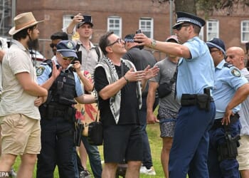 A pro-Palestine supporter wearing a keffiyeh was heckled by mourners at Bondi Beach