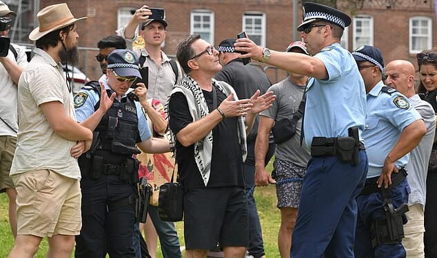 A pro-Palestine supporter wearing a keffiyeh was heckled by mourners at Bondi Beach