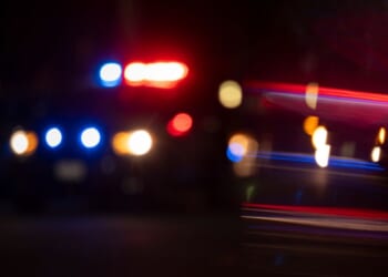 A blurry view of police lights flashing.