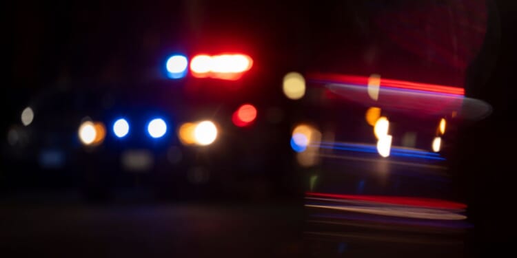 A blurry view of police lights flashing.