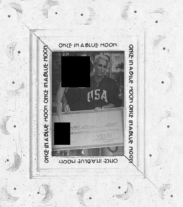 Epstein in a framed photo posing with check signed by Trump