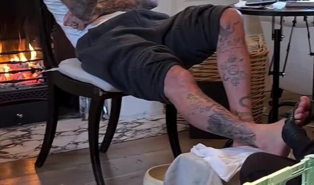Victoria Beckham, 51, captured her husband David, 50 (pictured) getting a home pedicure on Instagram on Wednesday as the family put on a brave face on after Brooklyn blocked them