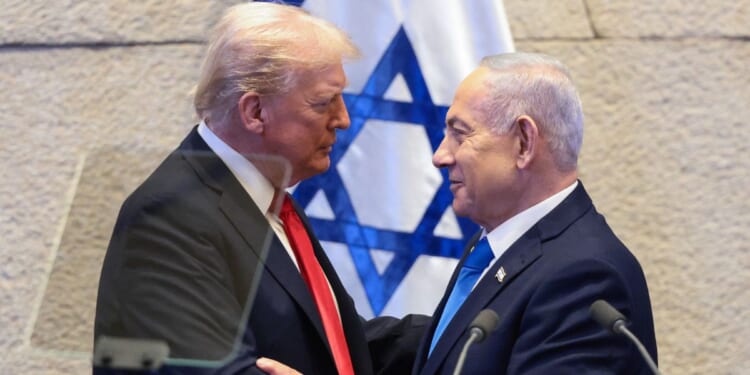 President Donald Trump speaks with Israeli Prime Minister Benjamin Netanyahu at the Israeli parliament, the Knesset, in Jerusalem on Oct. 13, 2025.