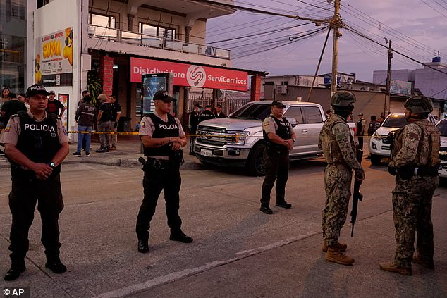 Police and army surround the butcher's shop where Mario Pineida was killed on Wednesday