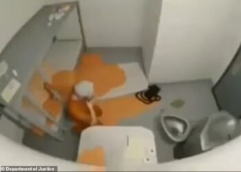 The grainy, 12-second clip appeared to show a man wearing orange prison gear on the floor of his cell