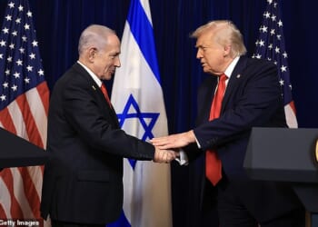 U.S. President Donald Trump shakes hands with Israeli Prime Minister Benjamin Netanyahu during a press conference at his Mar-a-Lago after being informed he will be awarded the Israel Prize
