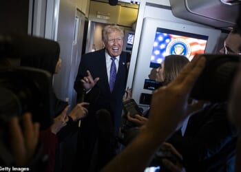 Donald Trump speaks to the press aboard Air Force One en-route to Washington, DC on Sunday