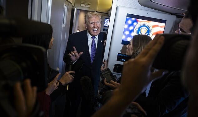 Donald Trump speaks to the press aboard Air Force One en-route to Washington, DC on Sunday