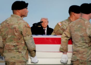 President Donald Trump salutes Wednesday as a U.S. Army carry team moves a flagged-draped transfer case containing the remains of Ayad Mansoor Sakat, a U.S. civilian working as an interpreter, at Dover Air Force Base in Dover, Delaware. Iowa National Guard members Sgt. William Nathaniel Howard and Sgt. Edgar Brian Torres-Tovar were also killed during a recent ambush by an Islamic State gunman in Syria. (Anna Moneymaker / Getty Images)