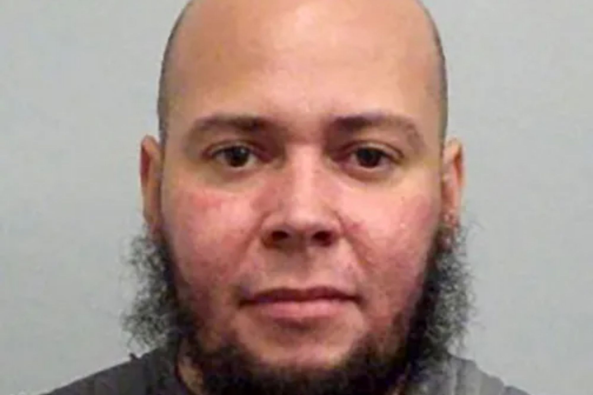 An image collage containing 1 images, Image 1 shows Mugshot of Liam Wall, 36, who is bald with a brown beard and wearing a black Nike shirt