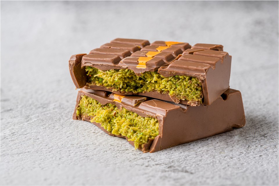 Dubai Chocolate bar with green kadayif and peanut butter on white stone table