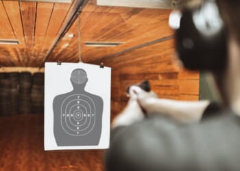 A file photo depicts a man practicing at a gun range. News reports lauded an Australian police officer for taking out two terrorists from 130 feet away during their shooting rampage Sunday at Sydney's Bondi Beach.