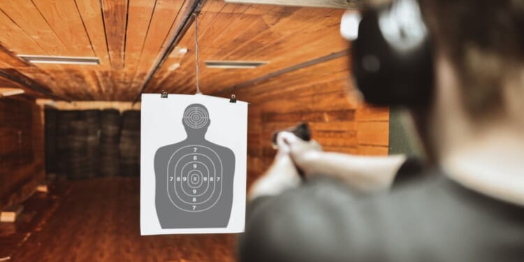 A file photo depicts a man practicing at a gun range. News reports lauded an Australian police officer for taking out two terrorists from 130 feet away during their shooting rampage Sunday at Sydney's Bondi Beach.
