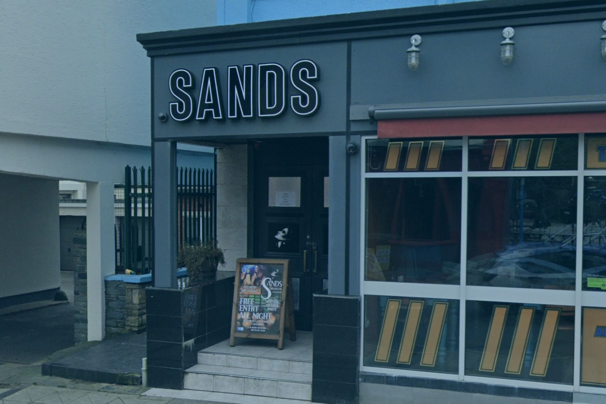 An image collage containing 1 images, Image 1 shows Exterior view of Sands Nightclub in Saundersfoot