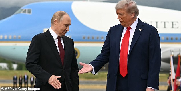 TOPSHOT - AFP PICTURES OF THE YEAR 2025  US President Donald Trump (R) reaches out to shake hands with Russian President Vladimir Putin as they pose on a podium on the tarmac after arrival at Joint Base Elmendorf-Richardson in Anchorage, Alaska, on August 15, 2025.. Putin is in Alaska at the invitation of Trump in his first visit to a Western country since he ordered the 2022 invasion of Ukraine that has killed tens of thousands of people. (Photo by ANDREW CABALLERO-REYNOLDS / AFP via Getty Images) / AFP PICTURES OF THE YEAR 2025