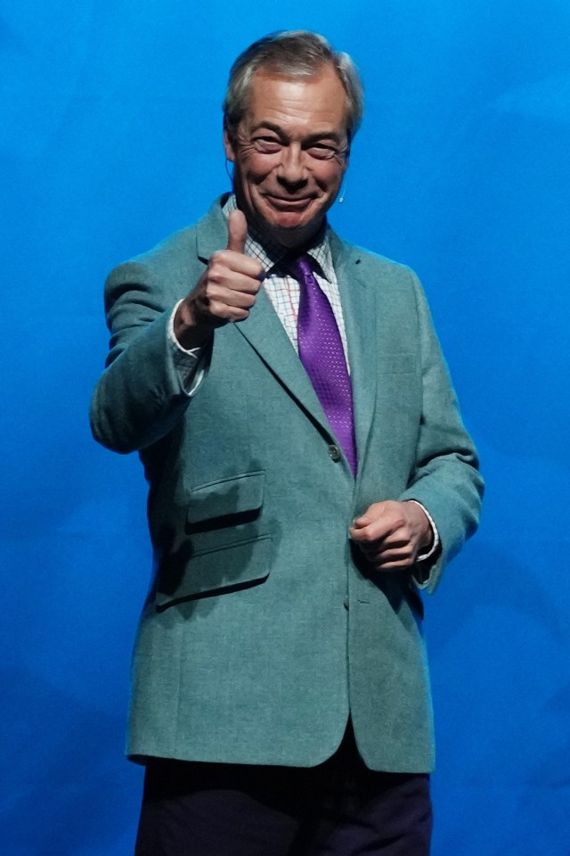 Reform UK Leader Nigel Farage giving a thumbs up at a rally.
