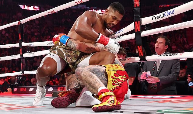 Anthony Joshua ends up on the canvas with Jake Paul - but went on to win the fight