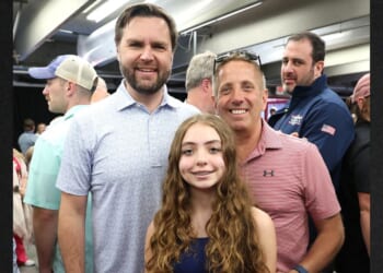 Former NASCAR Cup Series driver, Greg Biffle, right, and his daughter Emma Elizabeth Biffle posed for a photo with then-Republican vice presidential nominee J.D. Vance on Oct. 13, 2024, at Charlotte Motor Speedway in Concord, North Carolina. Biffle, his wife Cristina, daughter Emma and son Ryder were killed in a plane crash Thursday.