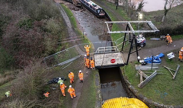 Aerial pictures show the vessels submerged in mud with bits of debris scattered round them and a long stretch of corrugated metal draped over