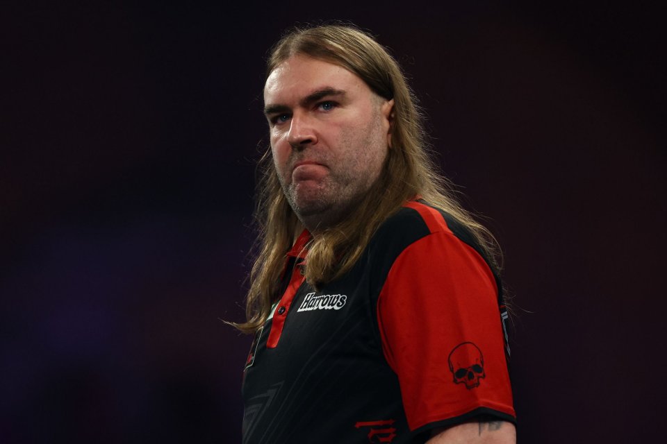 Darts player Joe Cullen looking towards the left with a serious expression.