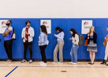 A group of voters stand in line at a community center so they can participate in early voting.