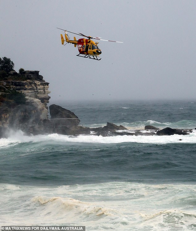 A helicopter is seen over the eastern suburbs coast after two tragedies unfolded overnight