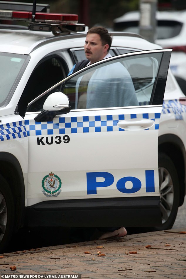 Constable Matthews was given a blanket following his heroic dash into the surf at Coogee