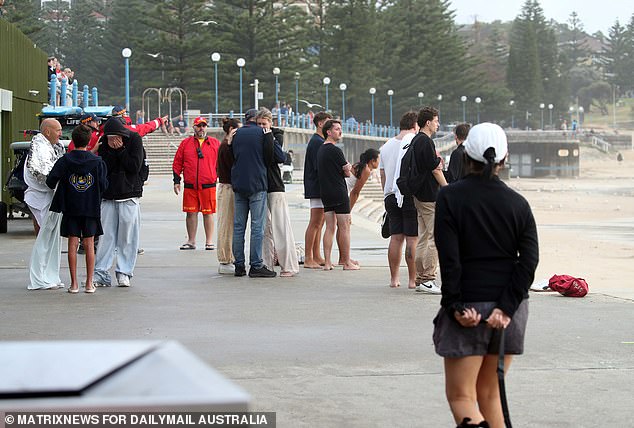 A crowd gathered at Coogee as a search was launched for a man believed to be aged in his 20s