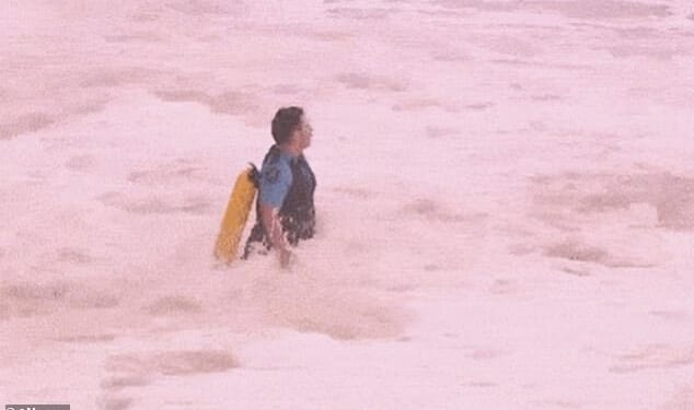 The cop - who the Daily Mail can reveal is NSW Police Constable Lucas Matthews - is seen running into the giant swell at Coogee Beach, in Sydney's eastern suburbs, fully clothed. He has been praised by colleagues and surf life savers for his efforts