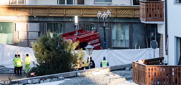 Police officers inspect the area where a fire broke out at the Le Constellation bar and lounge leaving people dead and injured, during New Year's celebration, in Crans-Montana, Swiss Alps, Switzerland, Thursday, Jan. 1, 2026. (Alessandro della Valle/Keystone via AP)