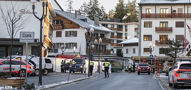 epa12620167 Police officers stand near the site where a fire broke out at Le Constellation bar and lounge following an explosion in the early hours of New Year's Eve, in Crans-Montana, Switzerland, 01 January 2026. According to regional media, the incident caused several deaths and injuries, while the exact cause of the blaze was not immediately known, Swiss cantonal police said.  EPA/ALESSANDRO DELLA VALLE