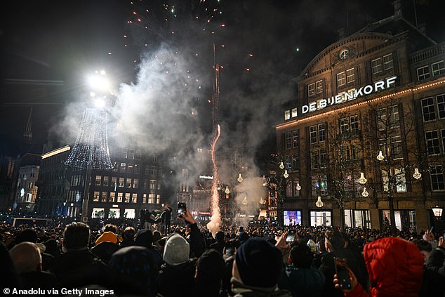 Police intervenes at Dam Square during New Year's Eve celebrations after disturbances broke out involving groups of youths setting off fireworks indiscriminately in Amsterdam