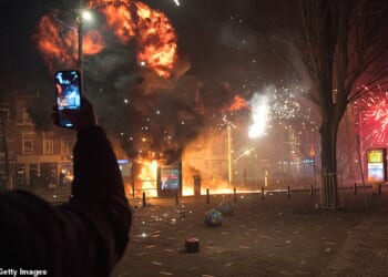 A tram stop is blown up with a makeshift explosive device as groups of residents from neighboring streets clash using fireworks in the Transvaal district on January 1, 2026 in The Hague