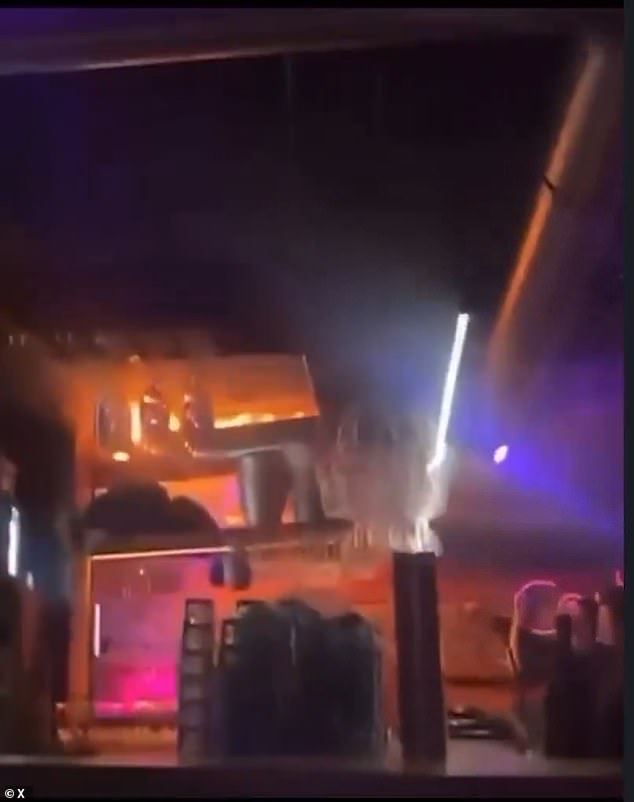 Panicked partygoers can be seen rushing to escape the venue, while others seem to remain underground filming the blaze, evidently not yet realising its danger