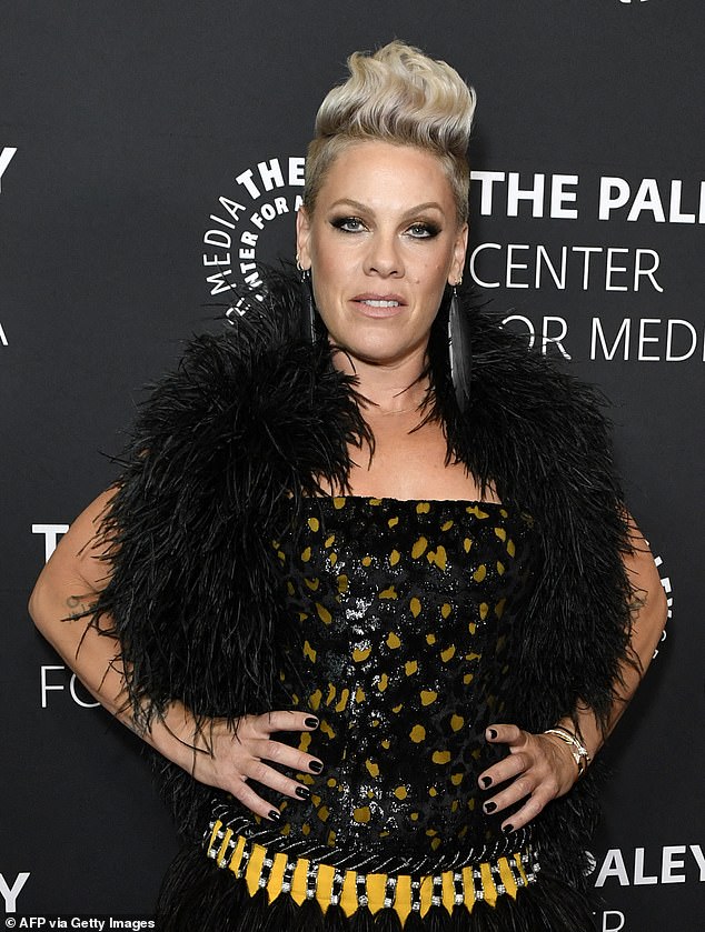 The 46-year-old pop star shared a smiling selfie taken from her hospital bed, featuring a white bandage on her neck; pictured in May 2024