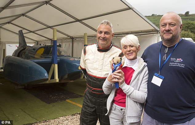 Bluebird was meticulously restored by a team led by Smith (right) with the blessing of Campbell's daughter Gina (centre, with mascot Mr Whoppit). It was then refloated with pilot Ted Walsh (left) at the helm