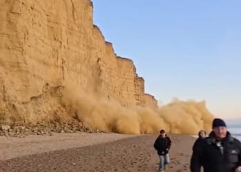 This is the moment beach walkers ran for their lives as a massive rockfall occurred in Britain's crumbling Jurassic Coast