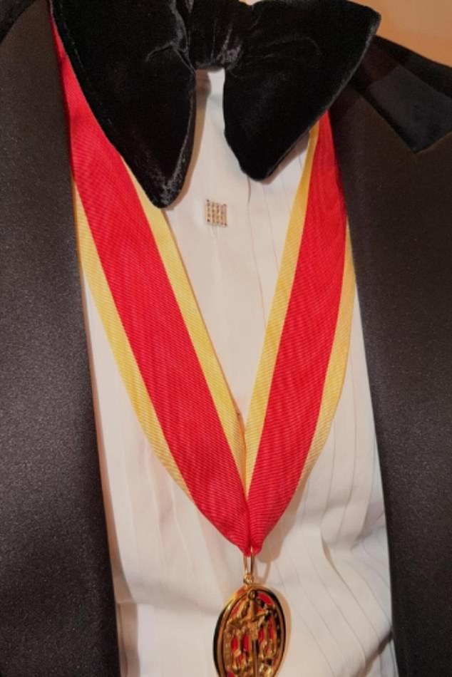 The pictures featured a number of moments from the Beckhams' year, including their summer yacht trip, David's medal from his Knighthood (pictured), a sweet snap showing him hugging Cruz as well as a number of images of Kim