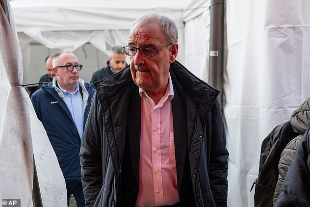 Swiss Federal President Guy Parmelin and the President of Crans-Montana, Nicolas Feraud, left, inspect the area where a fire broke out