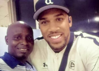 The Daily Mail has obtained a picture of Anthony Joshua as he smiled with a baggage handler called Solomon as he arrived in Nigeria before the fateful journey