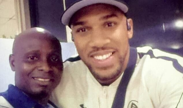 The Daily Mail has obtained a picture of Anthony Joshua as he smiled with a baggage handler called Solomon as he arrived in Nigeria before the fateful journey
