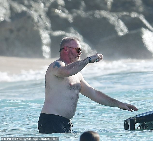Wayne, who is known for getting badly sunburnt, went shirtless as he headed out into the water
