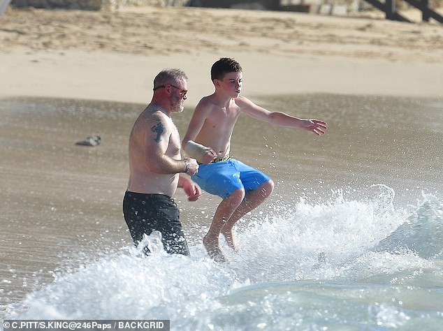 Klay jumped high in the water as he larked about in the sun with his dad
