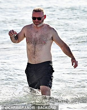 Shirtless Wayne rocked a pair of black board shorts