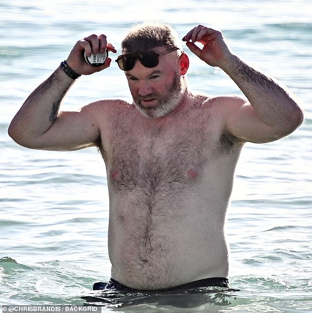 Wayne played catch with his sons in the water